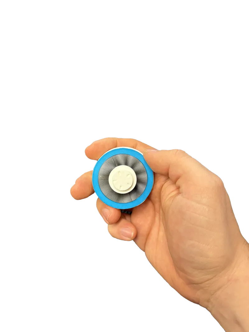 Image of a hand holding a white dial with a circular moire pattern and blue outlined.