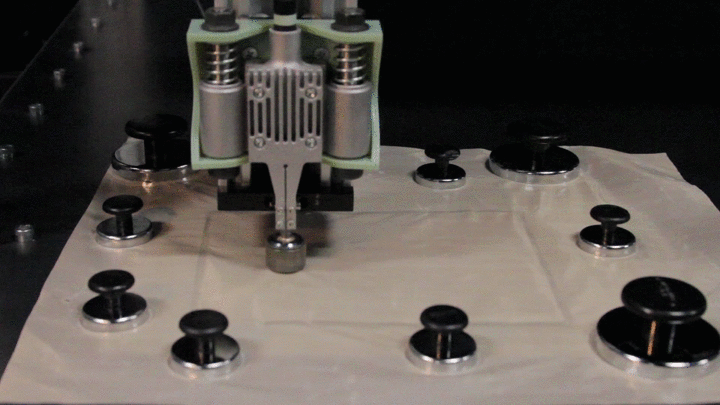 Animation of the fabrication process showing a heated ball transfer roll over two plastic sheets and weld them together.