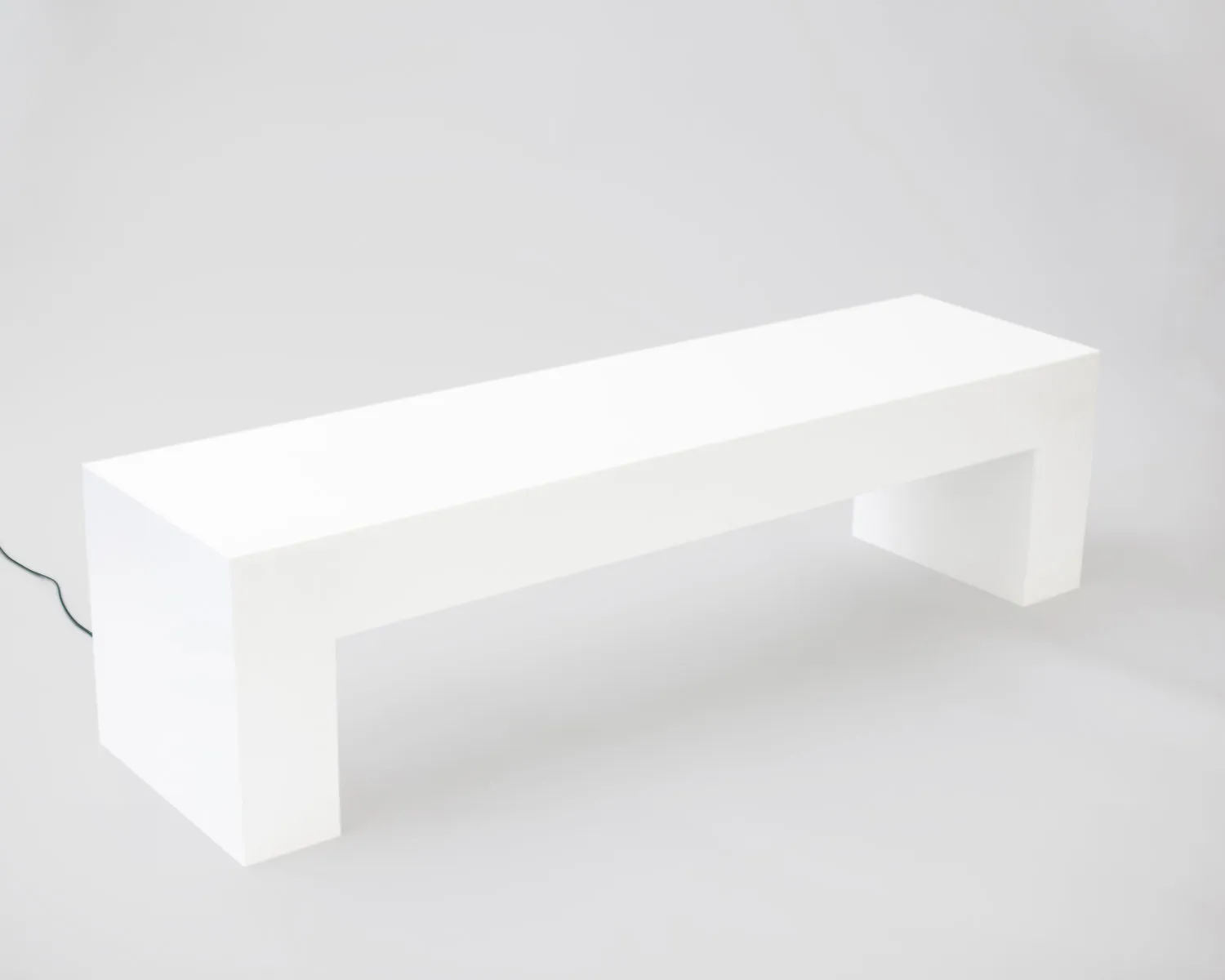 Studio photo showing a clean, minimal white bench.