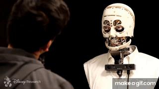 Animated gif of the robot blinking and looking at a person across from them, the robot mirrors the persons movements as they tilt their head from side to side.